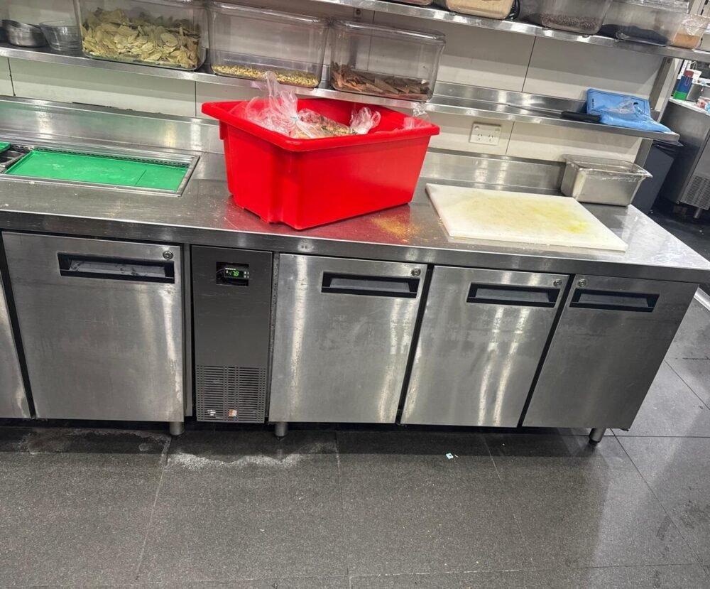 Commercial Fridge Repair Technician Servicing Unit